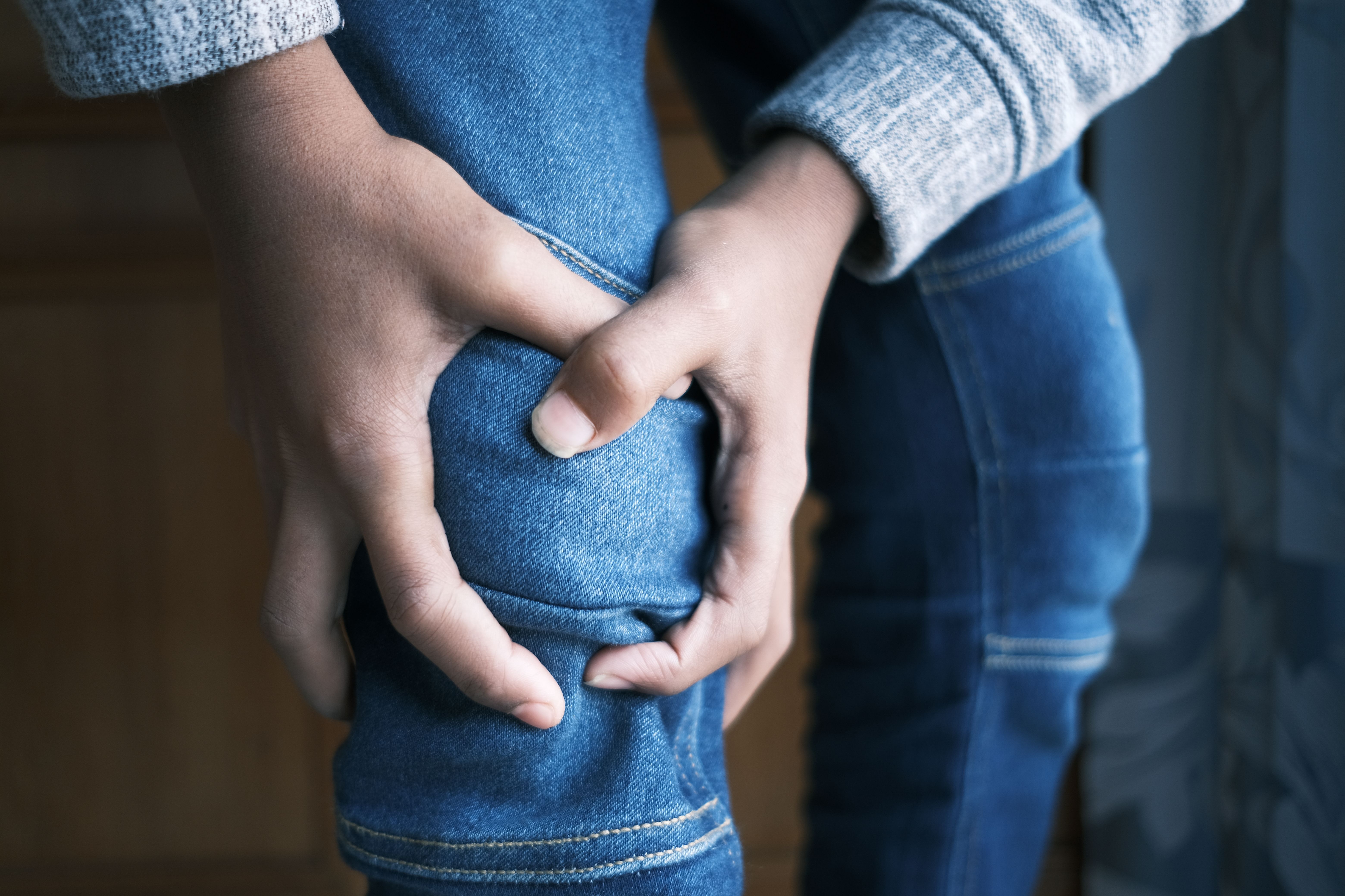 Person experiencing knee pain