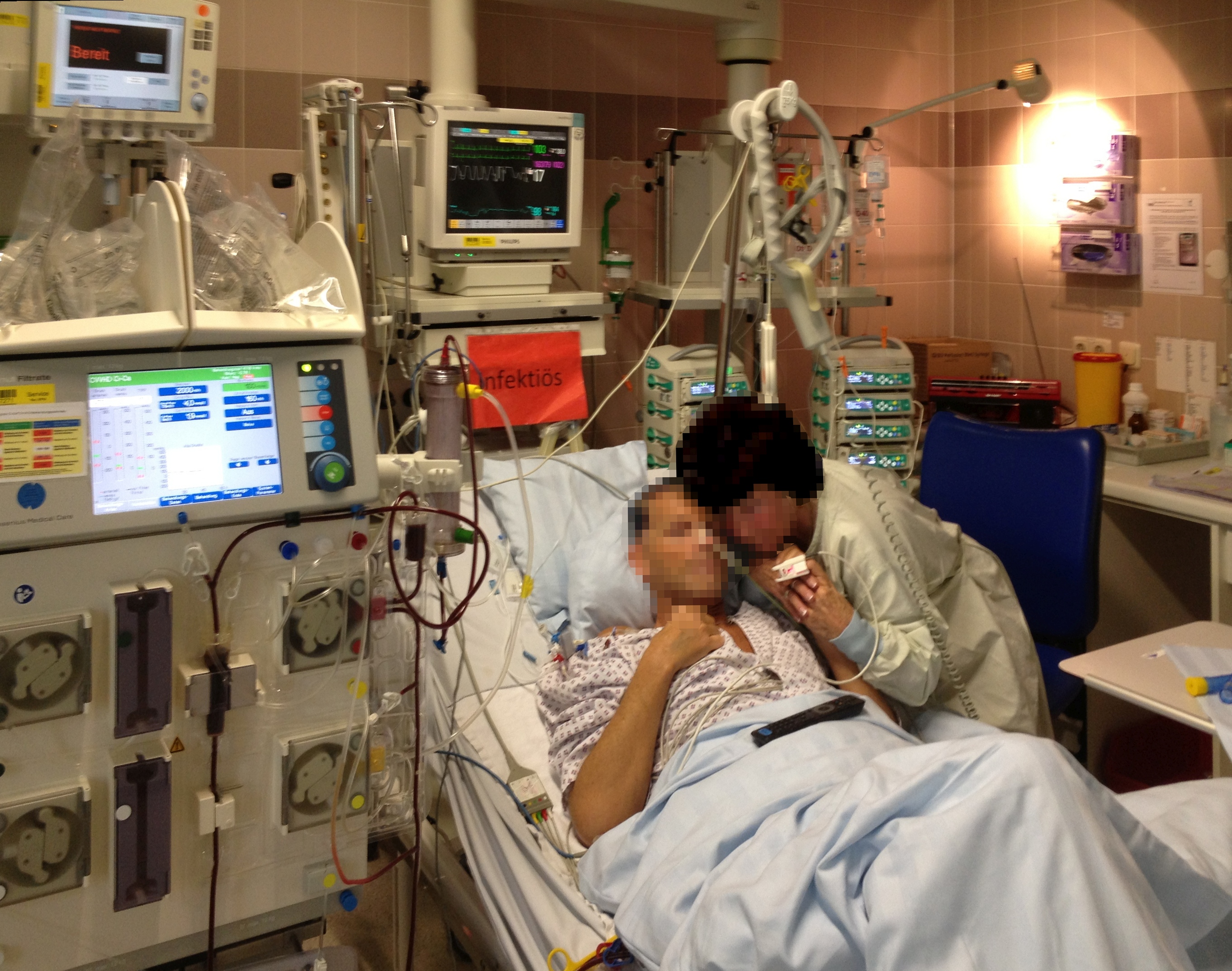 Patient in ICU with vital signs monitor