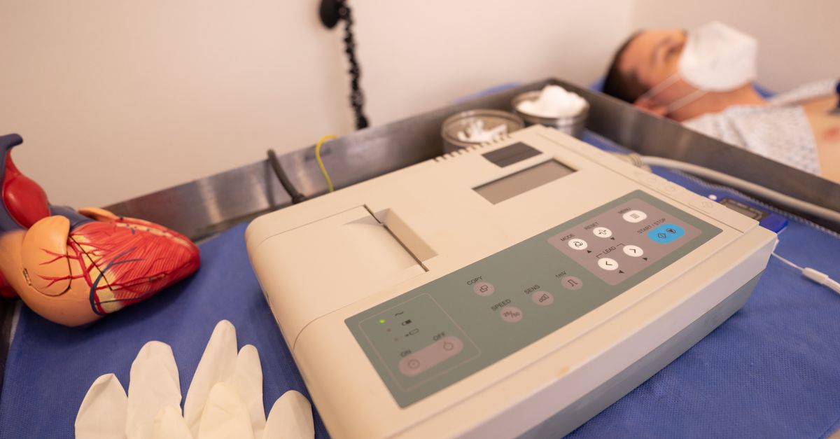 ECG machine and heart model in hospital setting representing cardiac care