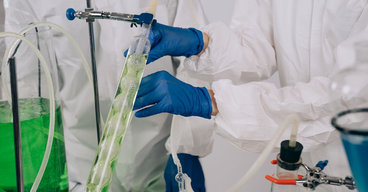 Researchers conducting chemistry experiment in laboratory