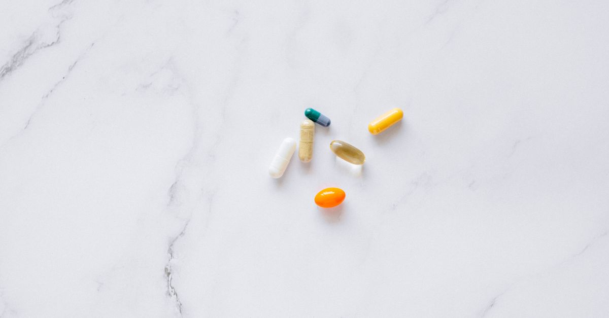 Supplement pills representing NMN metabolic therapy for autoimmune disease