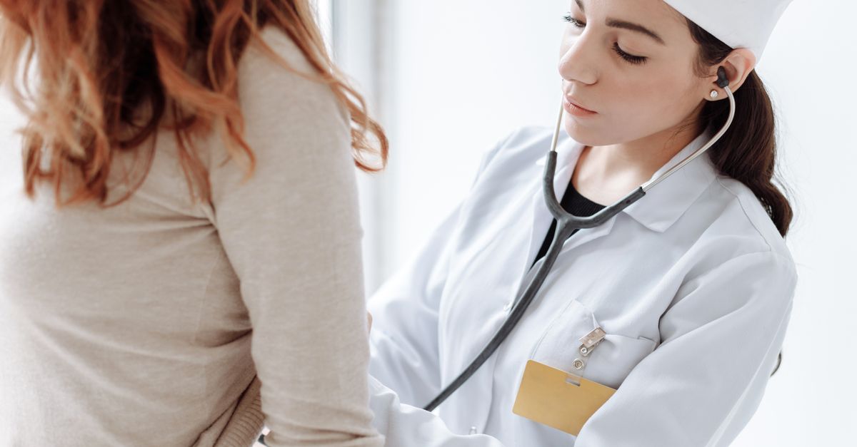 Doctor examining patient representing clinical trial for gene therapy