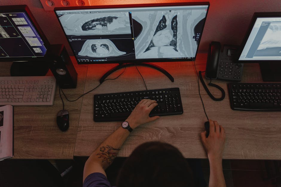 Doctor reviewing medical diagnostics on multiple monitors