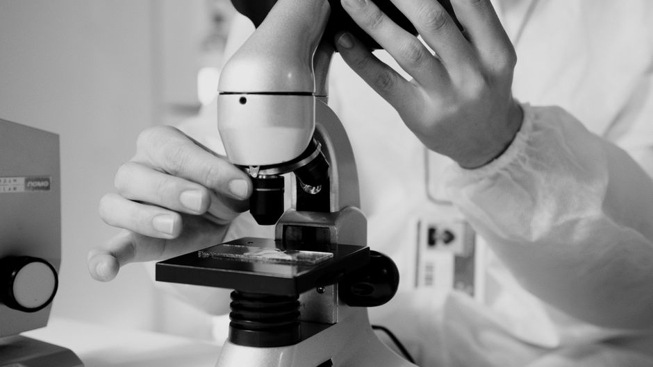 Scientist using microscope in laboratory