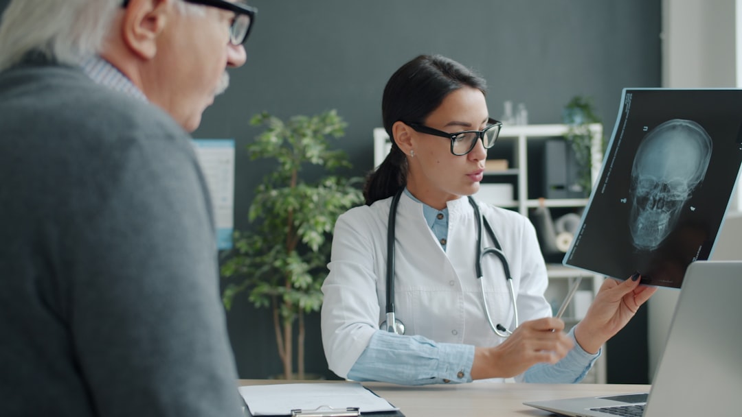 Doctor consulting with elderly patient about stroke