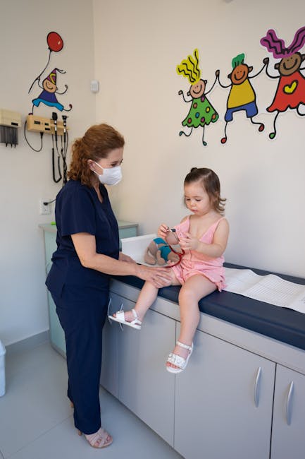 Doctor examining young girl in pediatric office