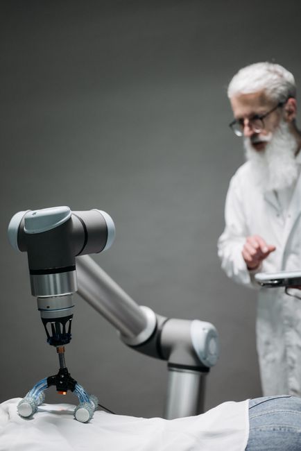 Scientist supervising robotic surgical equipment during operation
