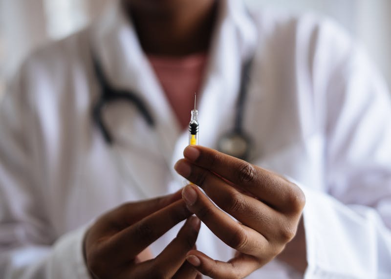 Doctor holding syringe representing China's domestic shingles vaccine development